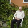 Nosher's dad sits in the garden