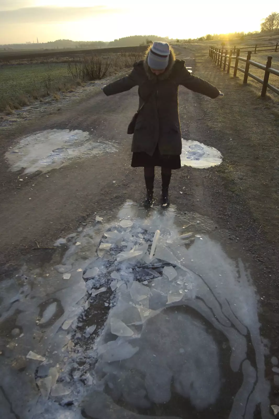 Isobel smashes up some ice as the sun sets at 3pm, from Gamla Uppsala, Uppsala County, Sweden - 16th December 2007