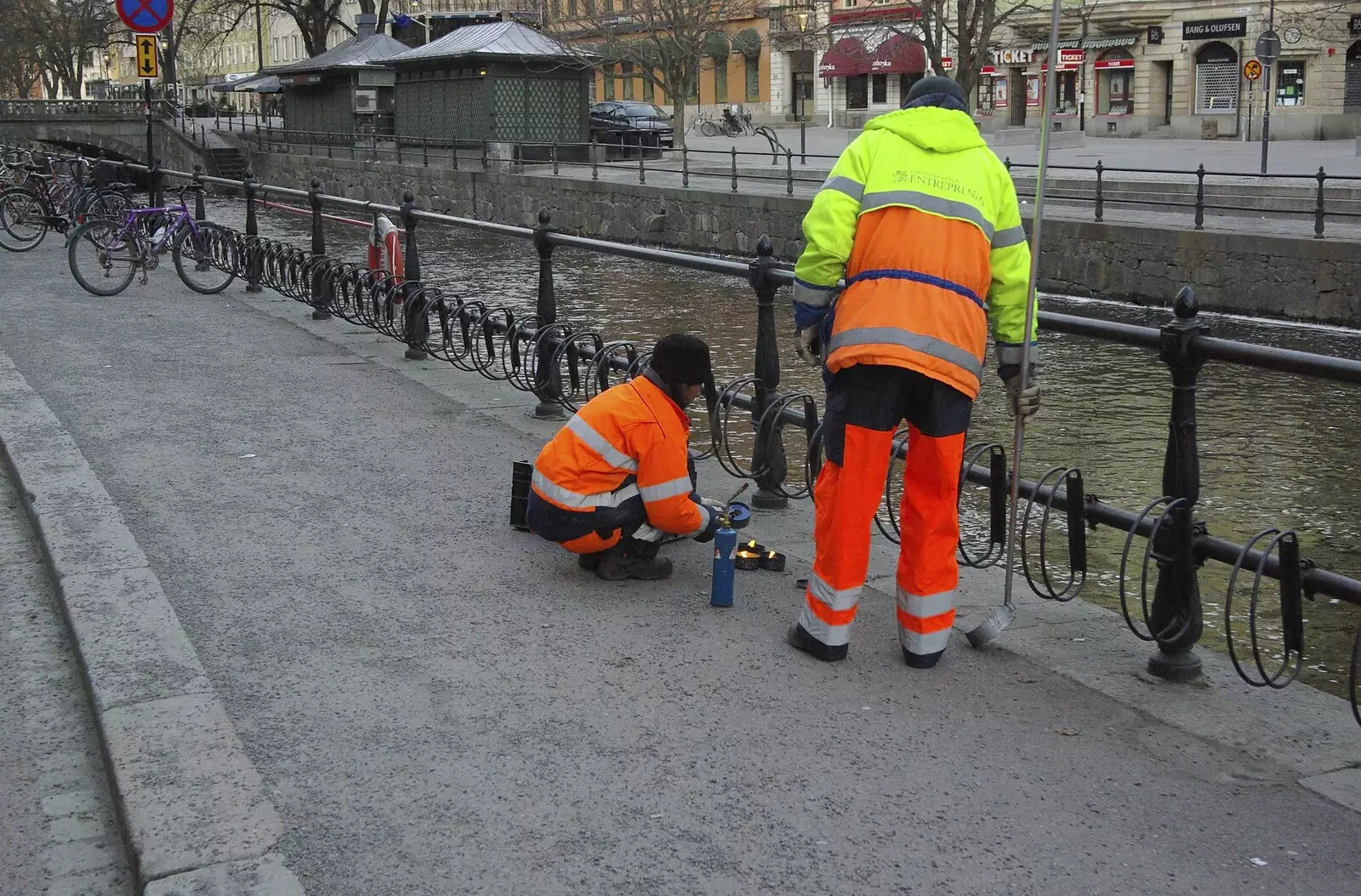 A work crew place lit candles along the river, from Gamla Uppsala, Uppsala County, Sweden - 16th December 2007