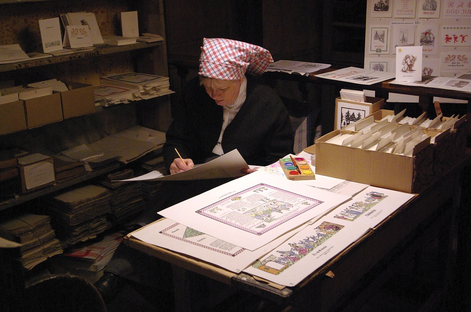 A woman hand-paints some printed illustrations from A Few Hours in Skansen, Stockholm, Sweden - 17th December 2007