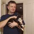Nosher holds the cat for a bit