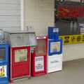 Newspaper boxes and a neon sign