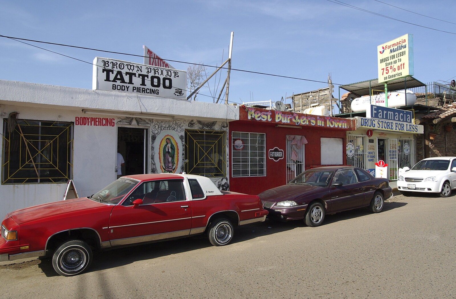 Rosarito and Tijuana, Baja California, Mexico - 2nd March 2008: Classic 1970s car outside Brown Pride Tattoo