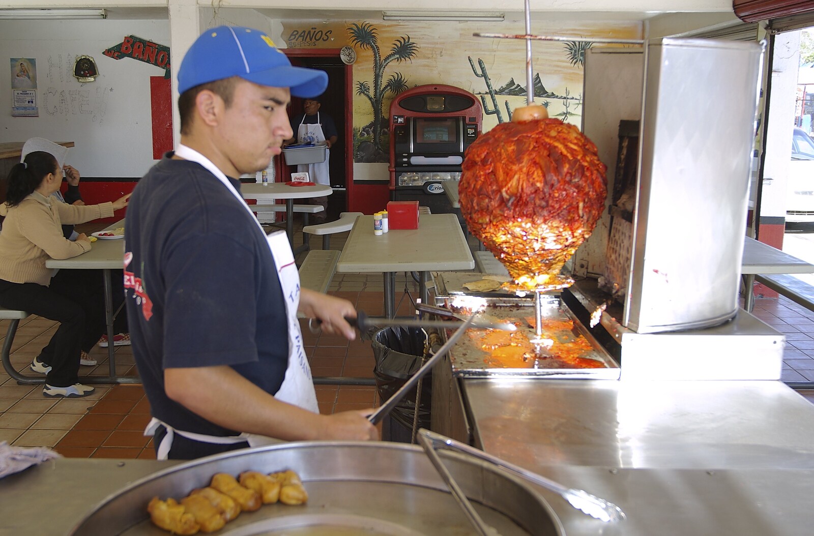 Rosarito and Tijuana, Baja California, Mexico - 2nd March 2008: The taco dude prepares to slice the al pastor pork