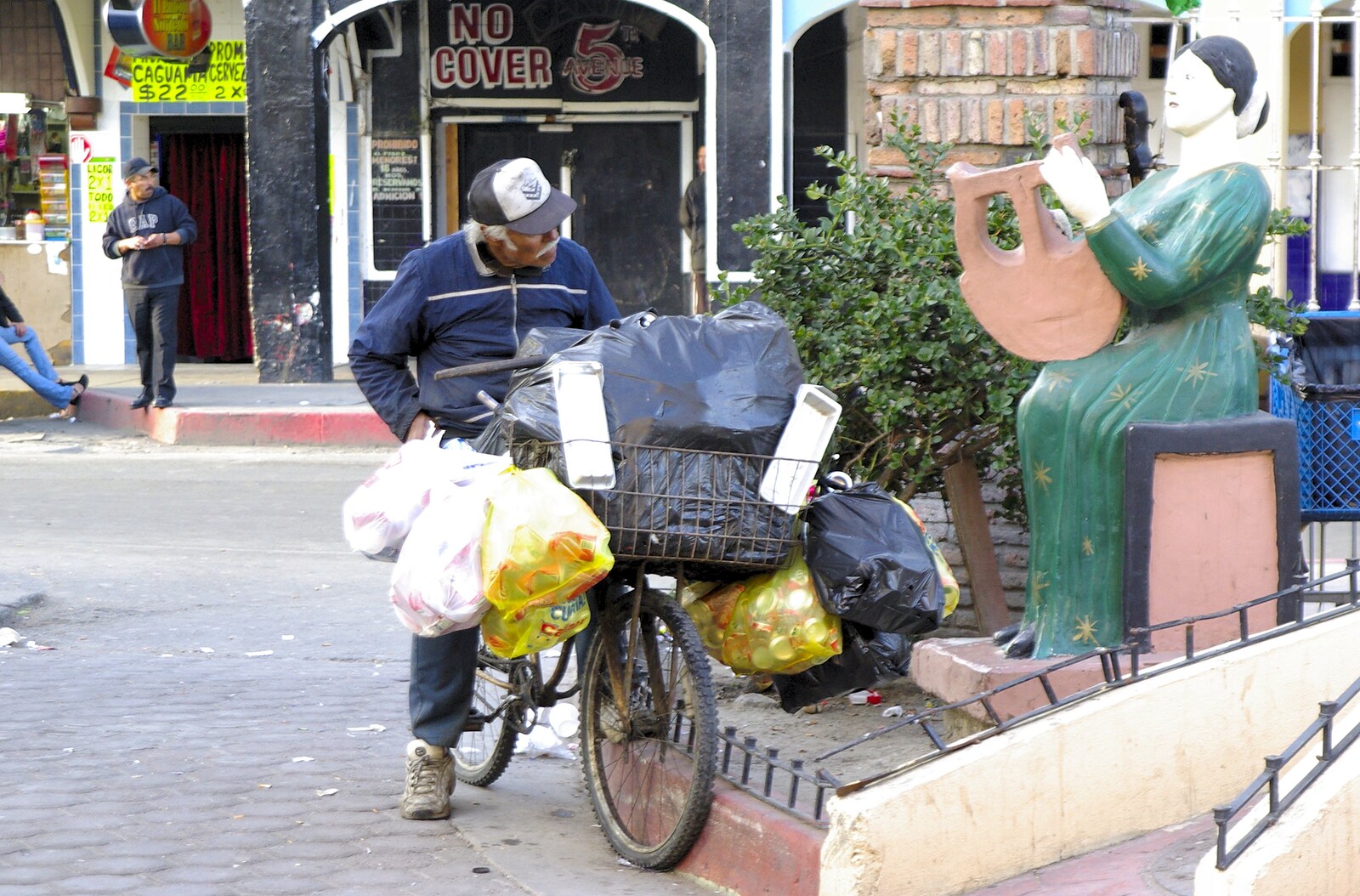 Rosarito and Tijuana, Baja California, Mexico - 2nd March 2008: Old man on a bike, with his wordly possessions