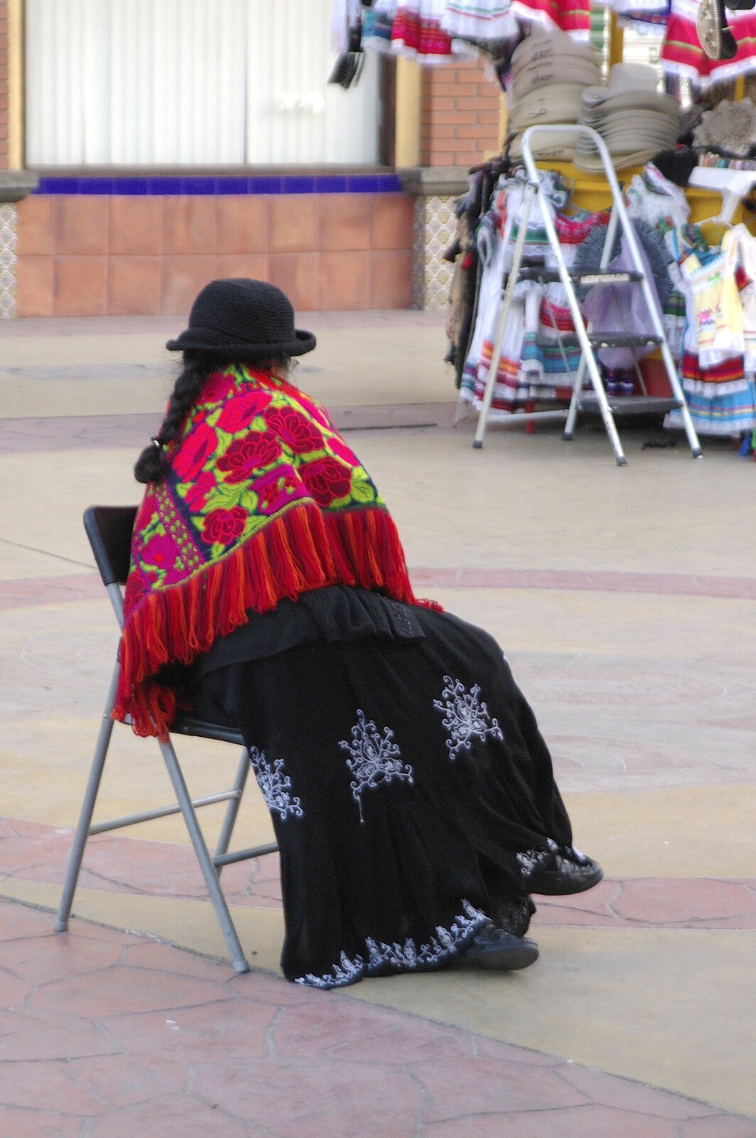 Rosarito and Tijuana, Baja California, Mexico - 2nd March 2008: A woman in some sort of traditional garb waits