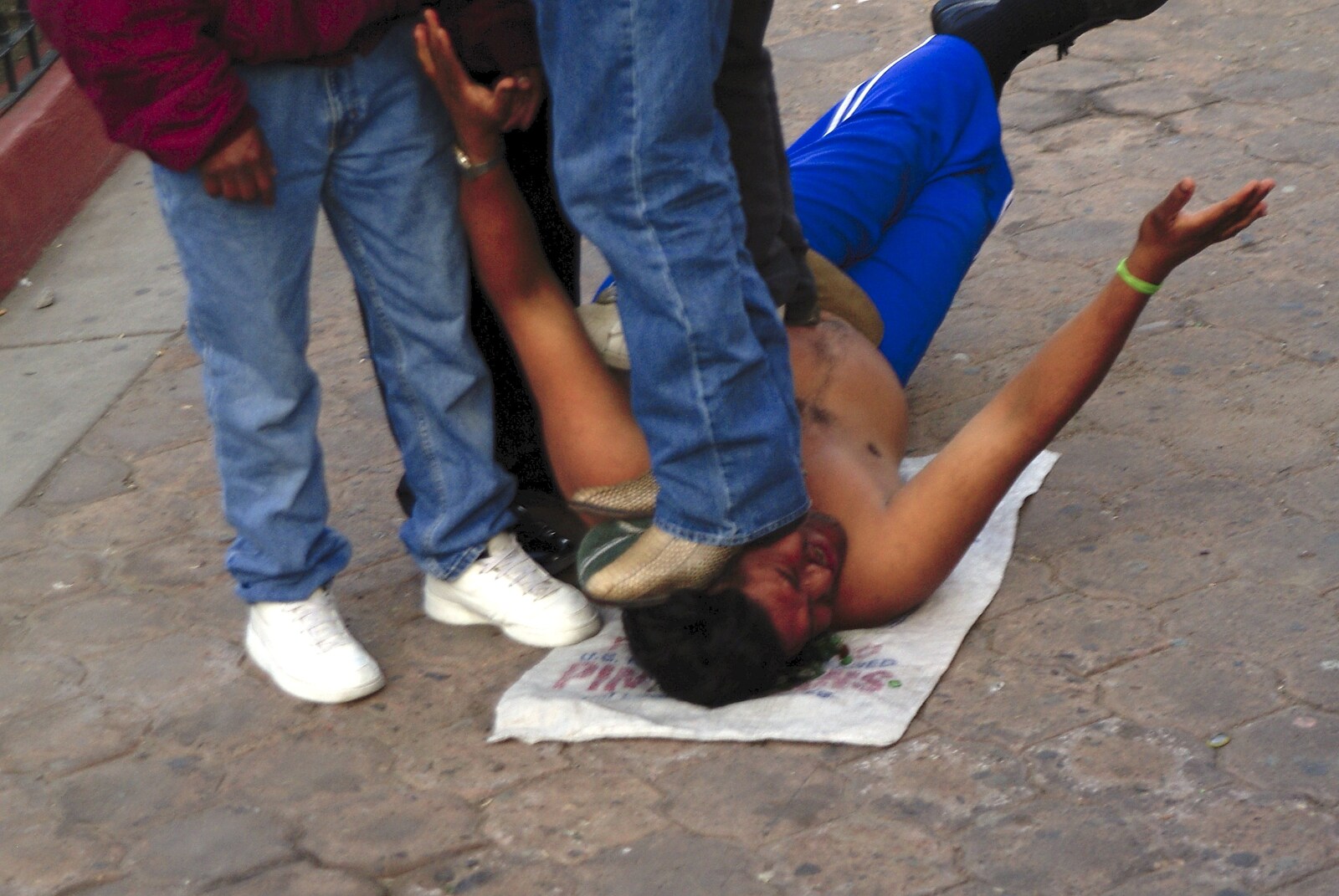 Rosarito and Tijuana, Baja California, Mexico - 2nd March 2008: An entertainer lies on broken glass and is stood on