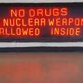 Amusing neon sign: no drugs or nuclear weapons allowed.