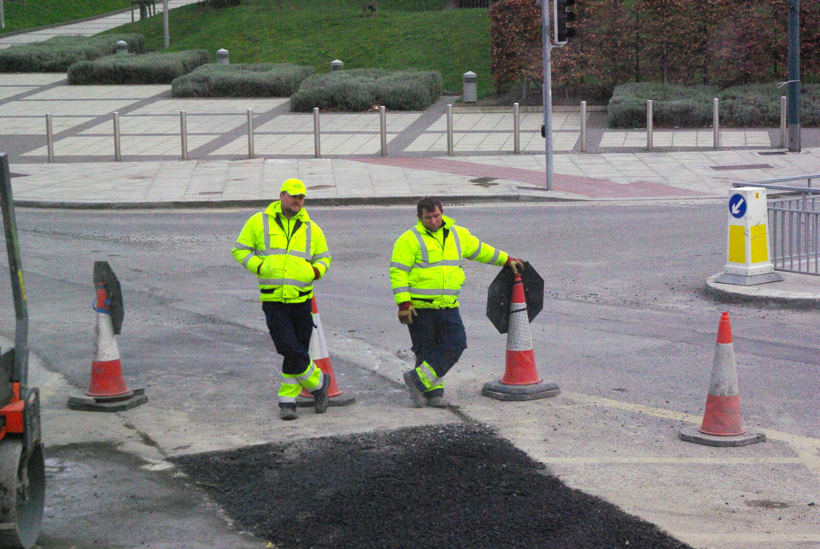Easter in Dublin, Ireland - 21st March 2008: A couple of workers do sod-all and watch tarmac set