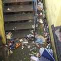 A basement staircase doubles as a convenient rubbish bin