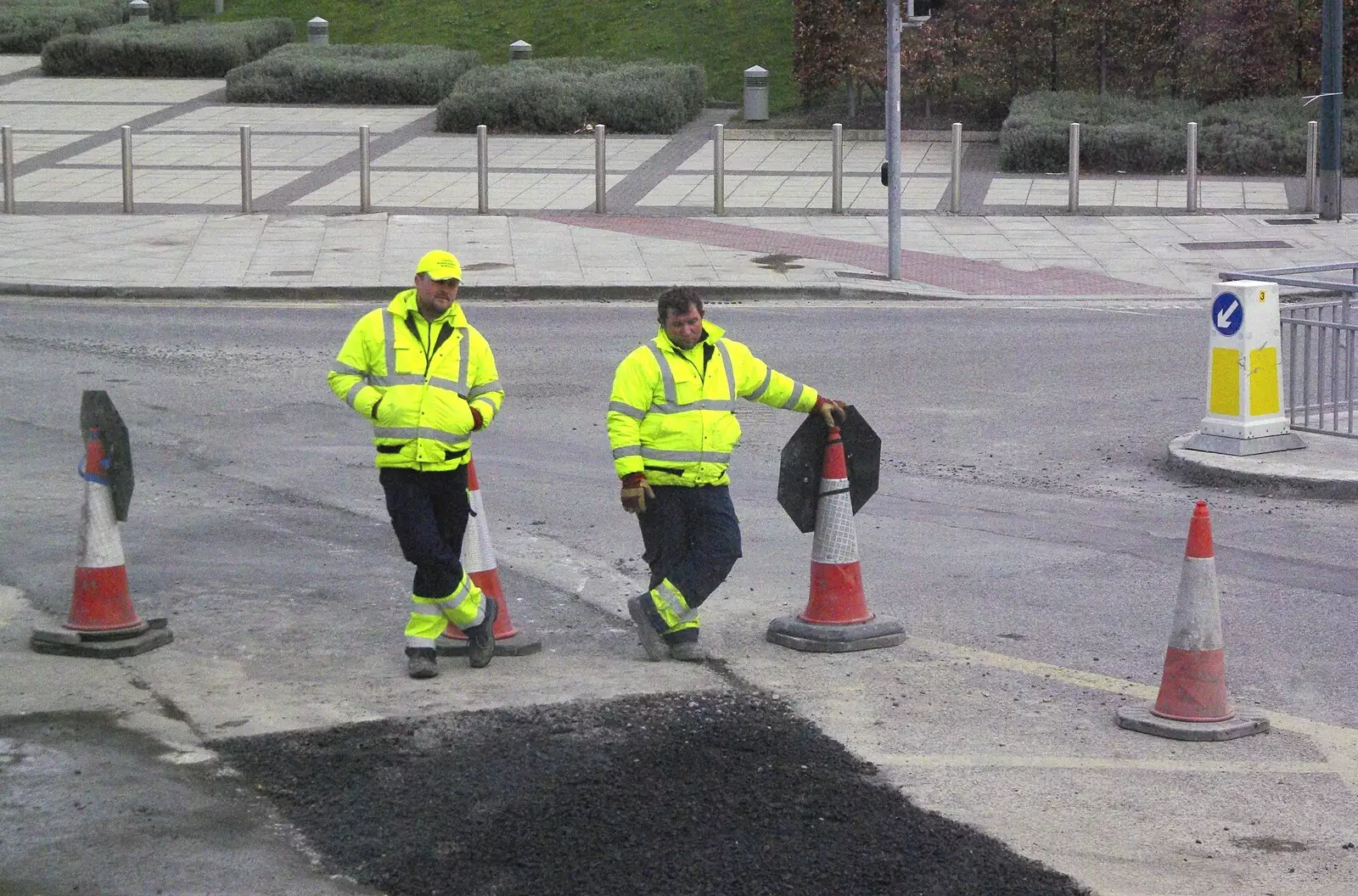 A couple of workers do sod-all and watch tarmac set, from Easter in Dublin, Ireland - 21st March 2008