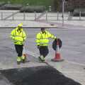 A couple of workers do sod-all and watch tarmac set