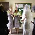 Jenny waits in the entrance porch, with the bridesmaids, for the rain to stop a bit