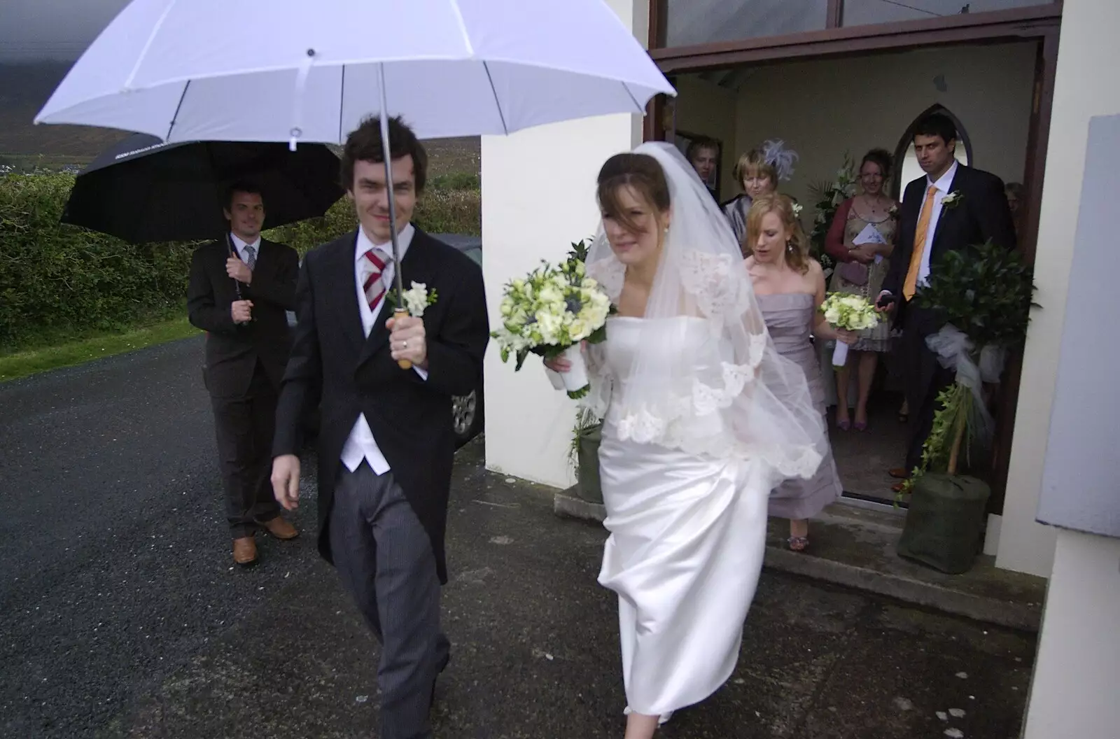 Paul shelters Jenny with a huge golf umbrella, from Paul and Jenny's Wedding, Tralee, County Kerry, Ireland - 3rd May 2008