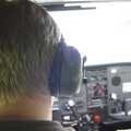Nosher, with a pair of cans installed on the head, goes throught the pre-flight checklist