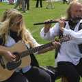 A hairy guitarist and flautist play folk music