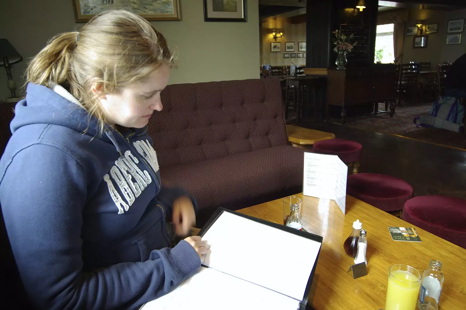 Isobel scopes the menu in the Cat and Fiddle, from Driving a Racing Car, Three Sisters Racetrack, Wigan, Lancashire - 24th June 2008