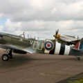 The Grace Spitfire, with Mustang 'Janie' (both aircraft are loosely related by engine) in the background