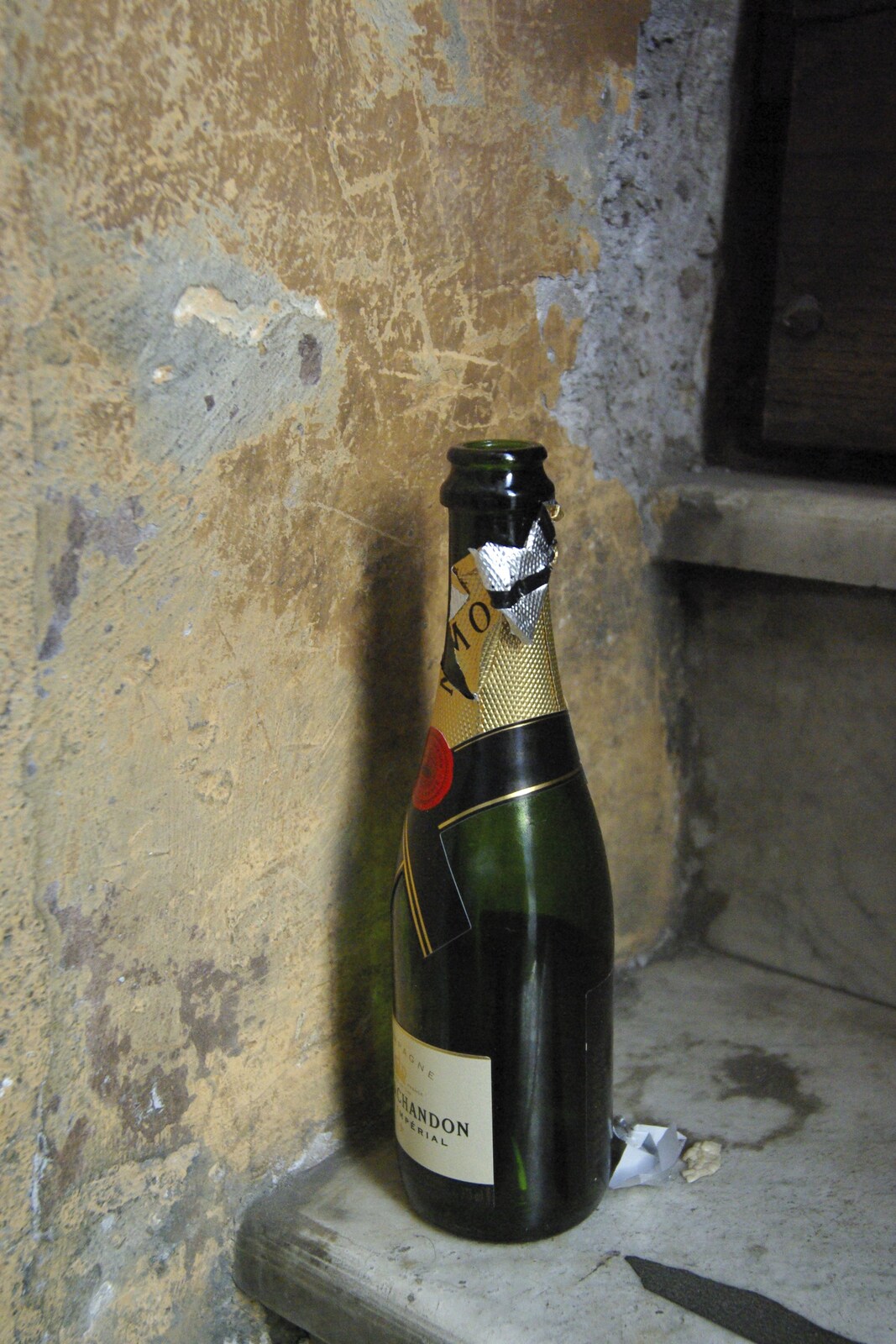 A Sojourn in The Eternal City, Rome, Italy - 22nd July 2008: Down-and-out in Rome: a discarded champagne bottle on a step