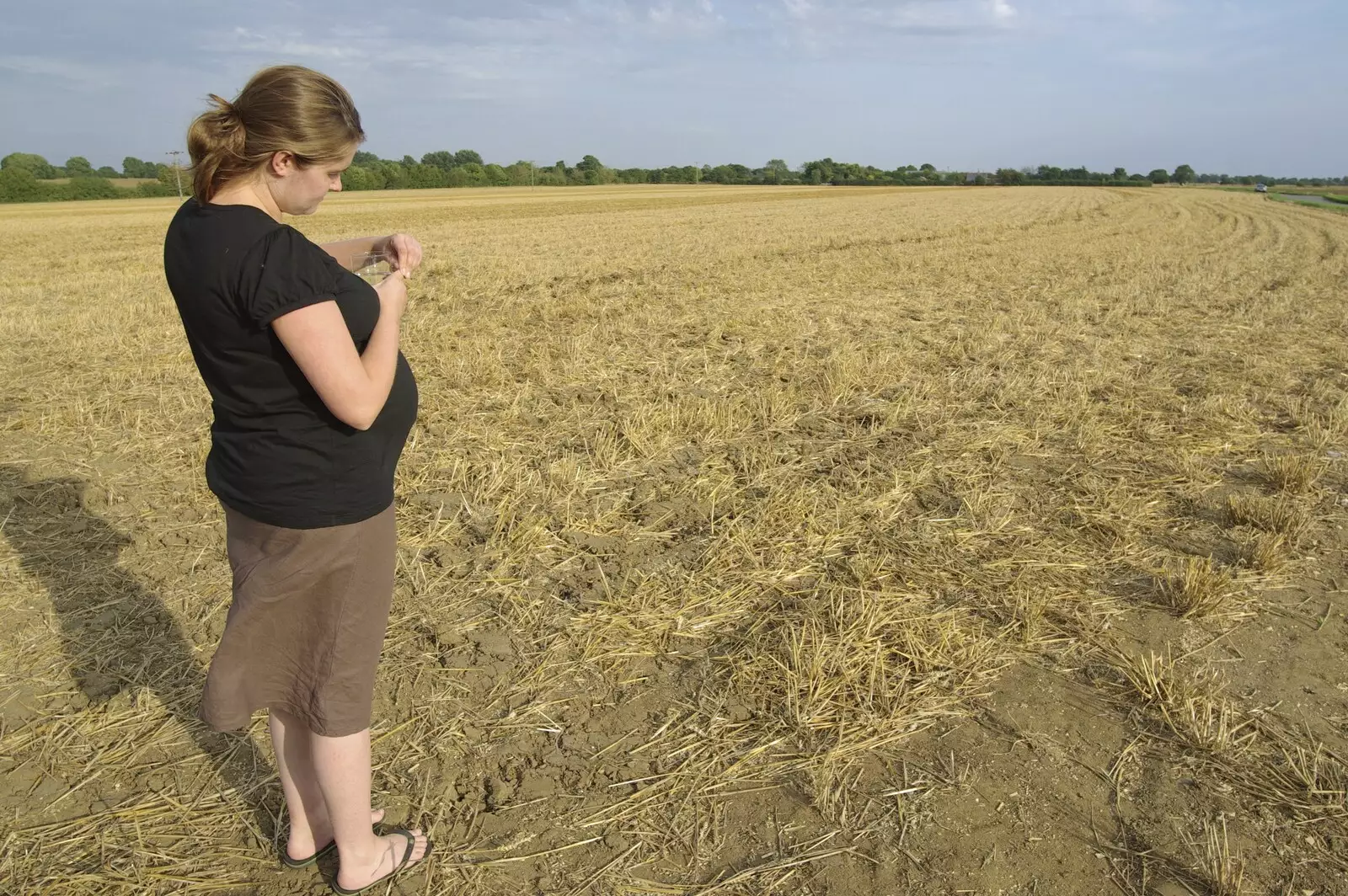 Isobel stands in a stubble field, from Sam and Daisy at The Cherry Tree, and Sis and Matt Visit, Suffolk - 14th September 2008