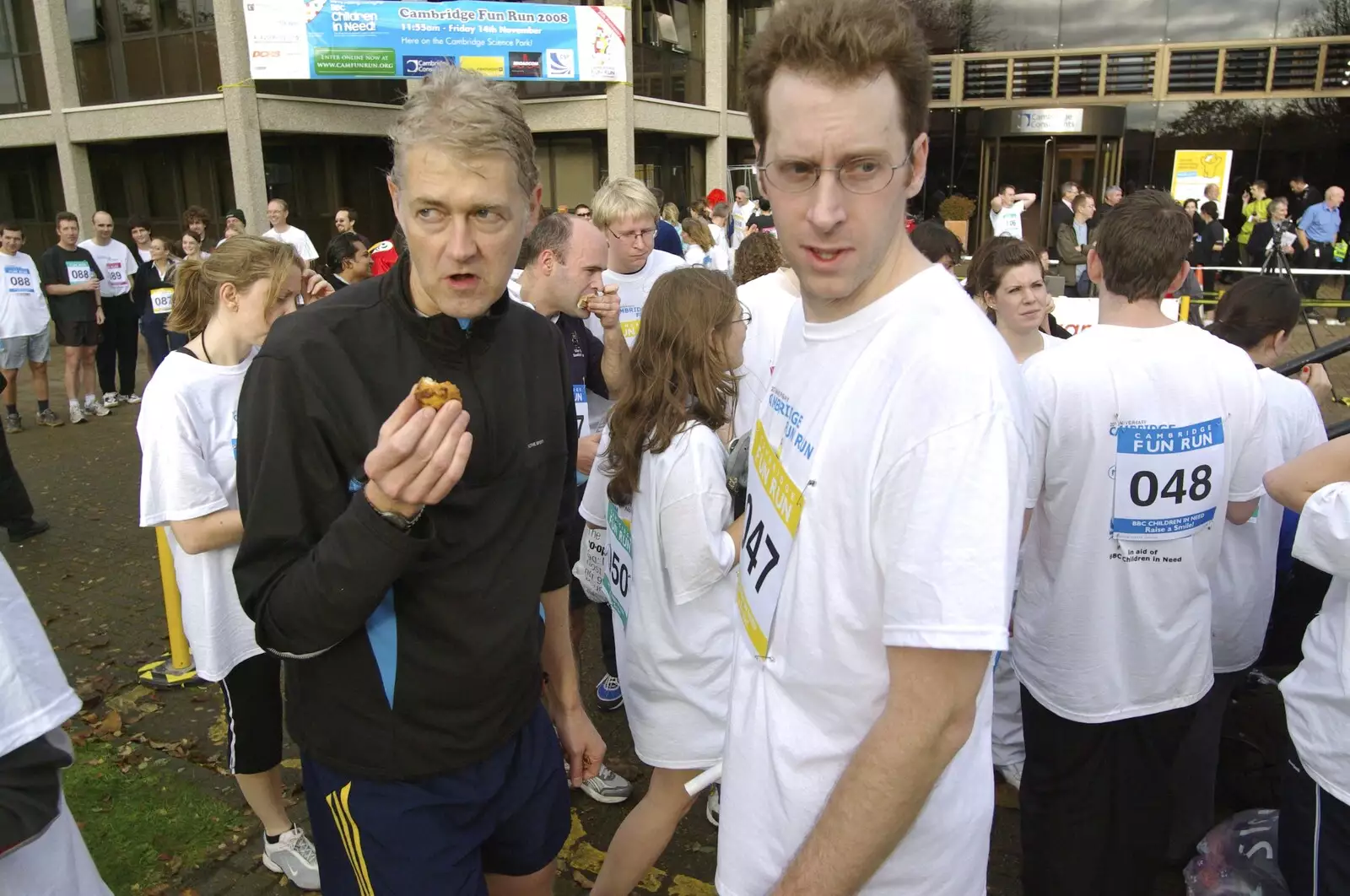 Steve and Brett furtively scoff muffins, from The Cambridge Fun Run, Milton Road, Cambridge - 14th November 2008