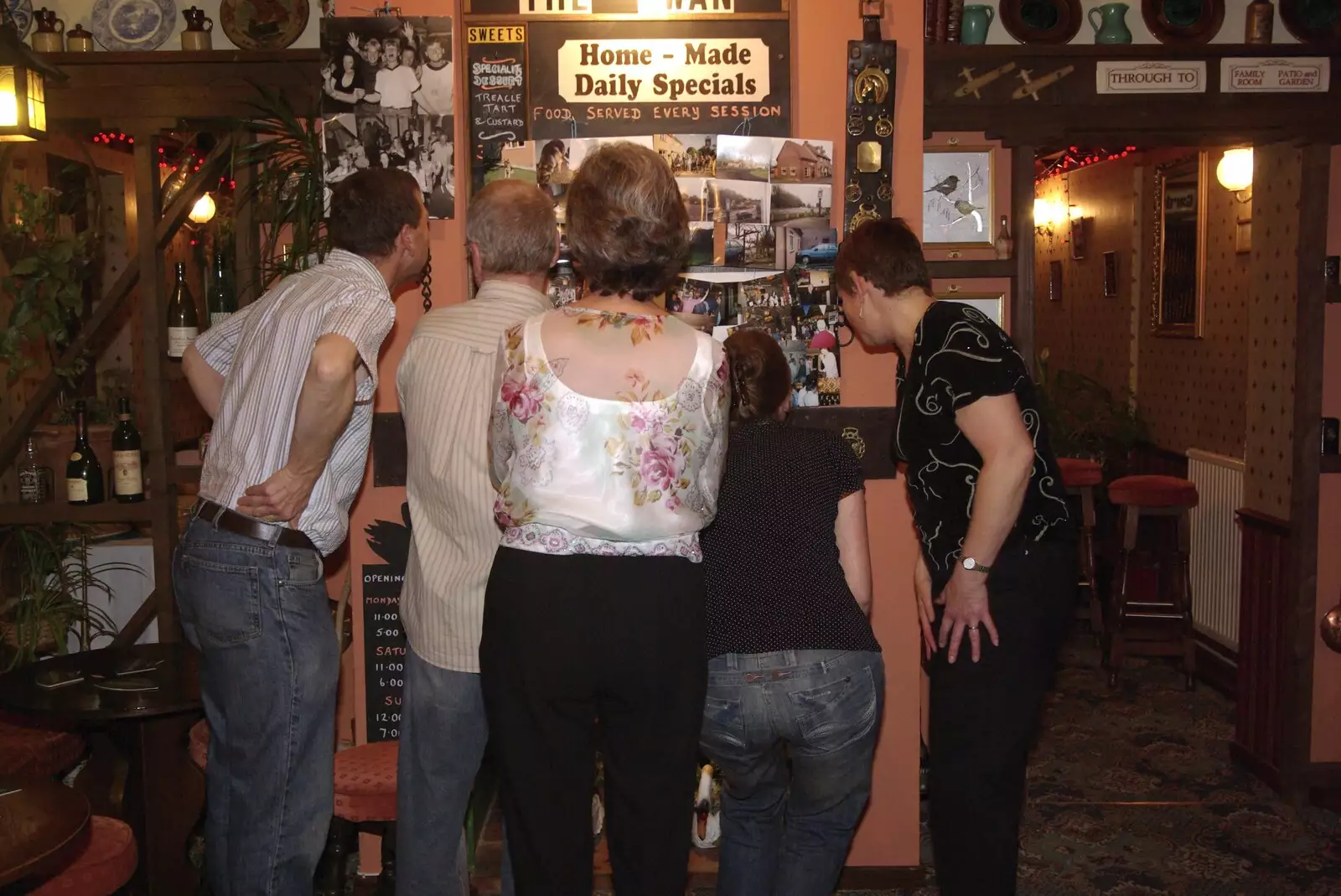 Crowding around looking at photos, from The Swan Inn's 25th Anniversary, Brome, Suffolk - 14th November 2008