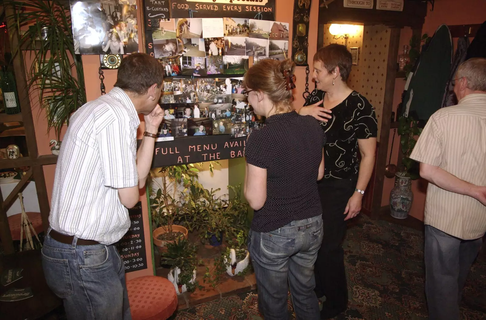 Apple, Suey and Pippa look at photos, from The Swan Inn's 25th Anniversary, Brome, Suffolk - 14th November 2008