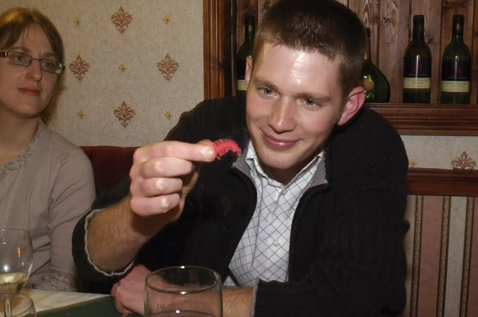 Phil inspects a melted plastic caterpillar, from The BSCC Christmas Dinner, The Swan Inn, Brome, Suffolk - 6th December 2008