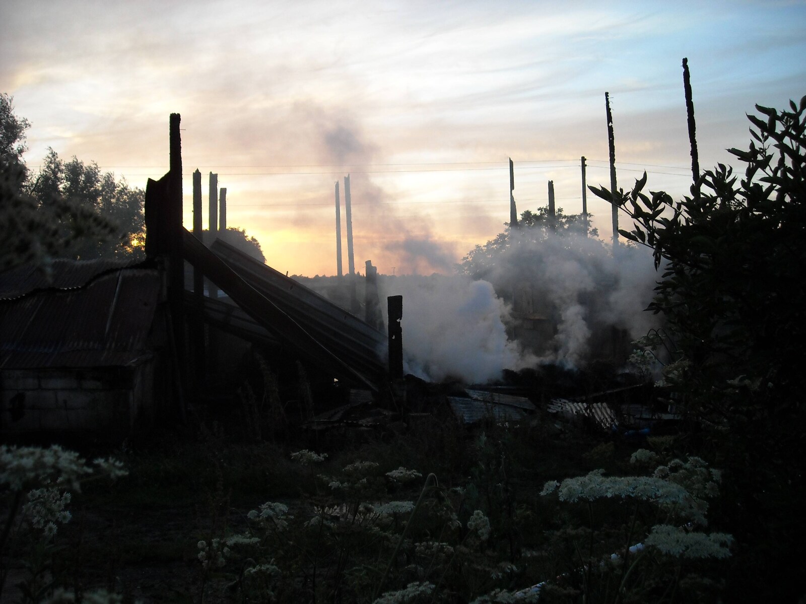 Steam and smoke drift away into the sunset from A Fire at Valley Farm, Thrandeston, Suffolk - 24th June 2009