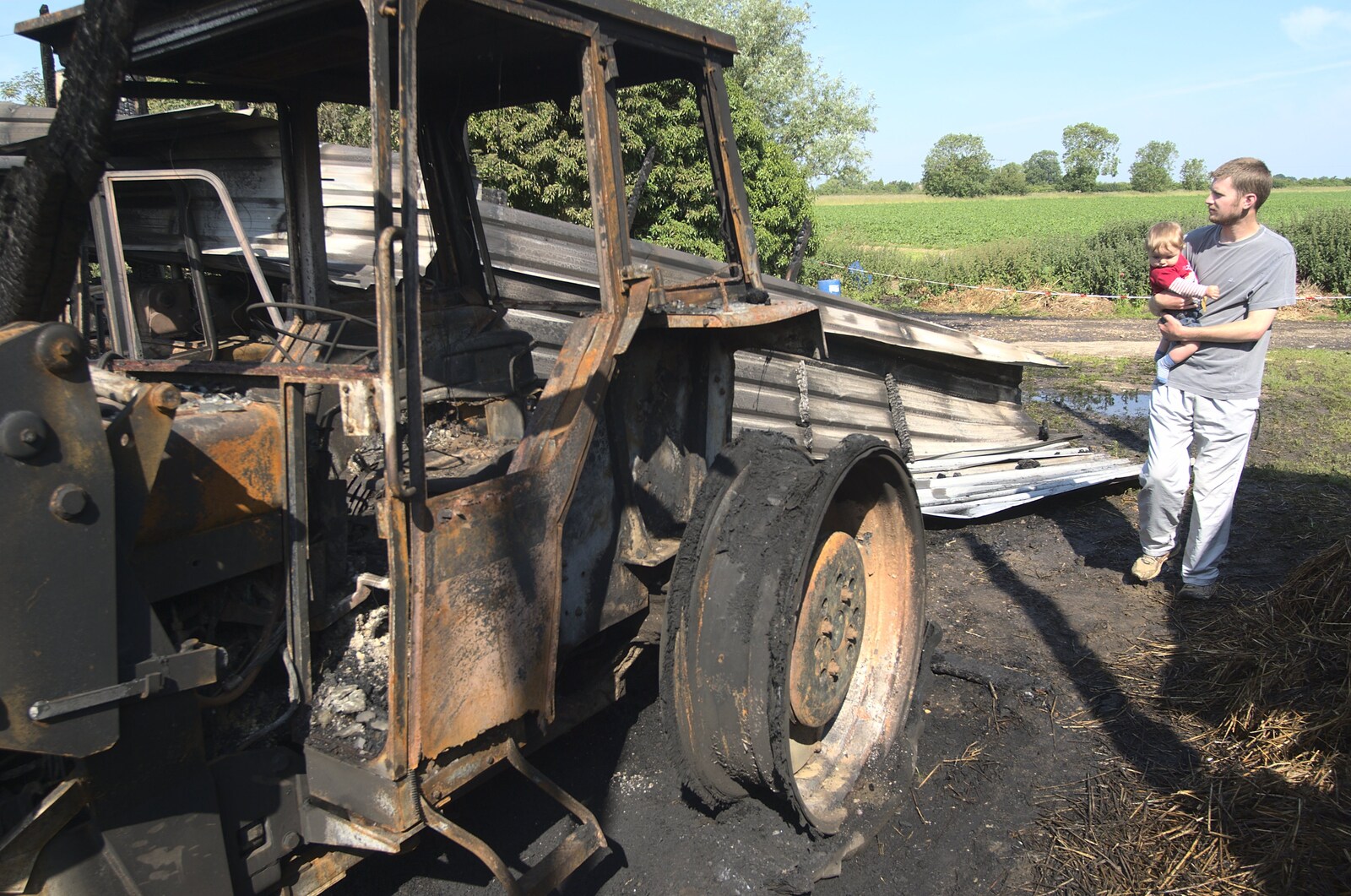 Fred gets a look at the burned-out tractor from A Fire at Valley Farm, Thrandeston, Suffolk - 24th June 2009