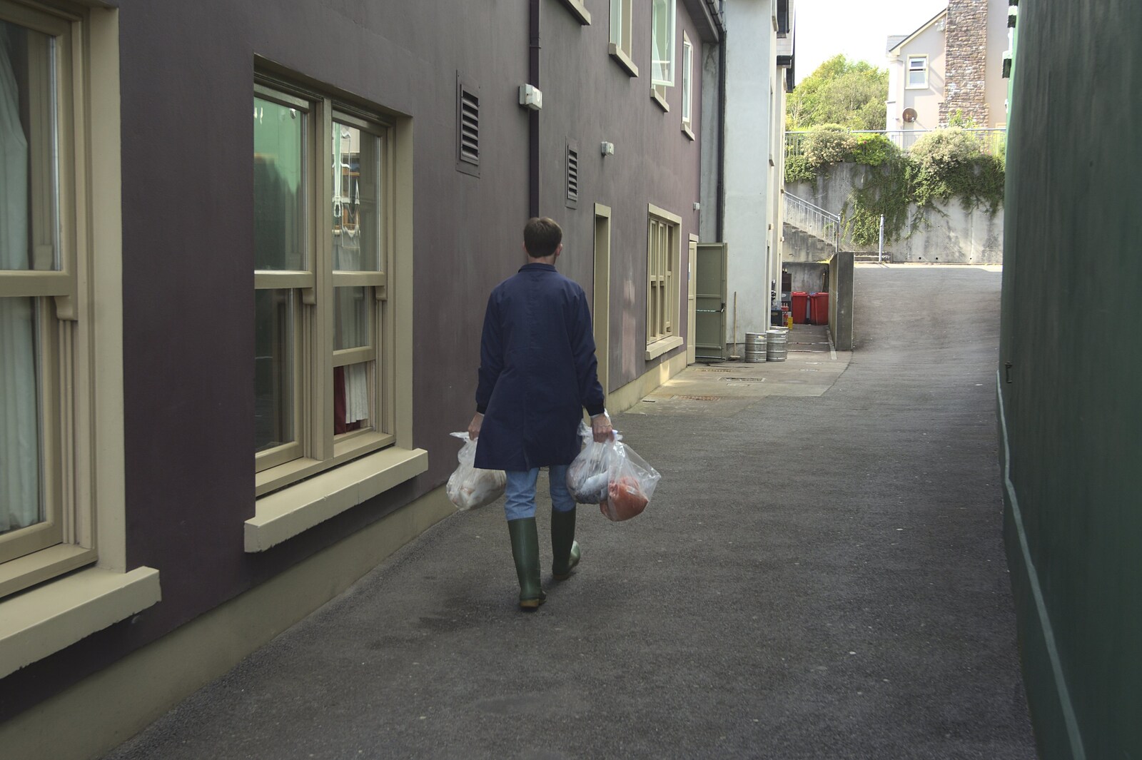 Some dude carries bags of fish round the back streets from A Trip to Dingle, County Kerry, Ireland - 21st July 2009
