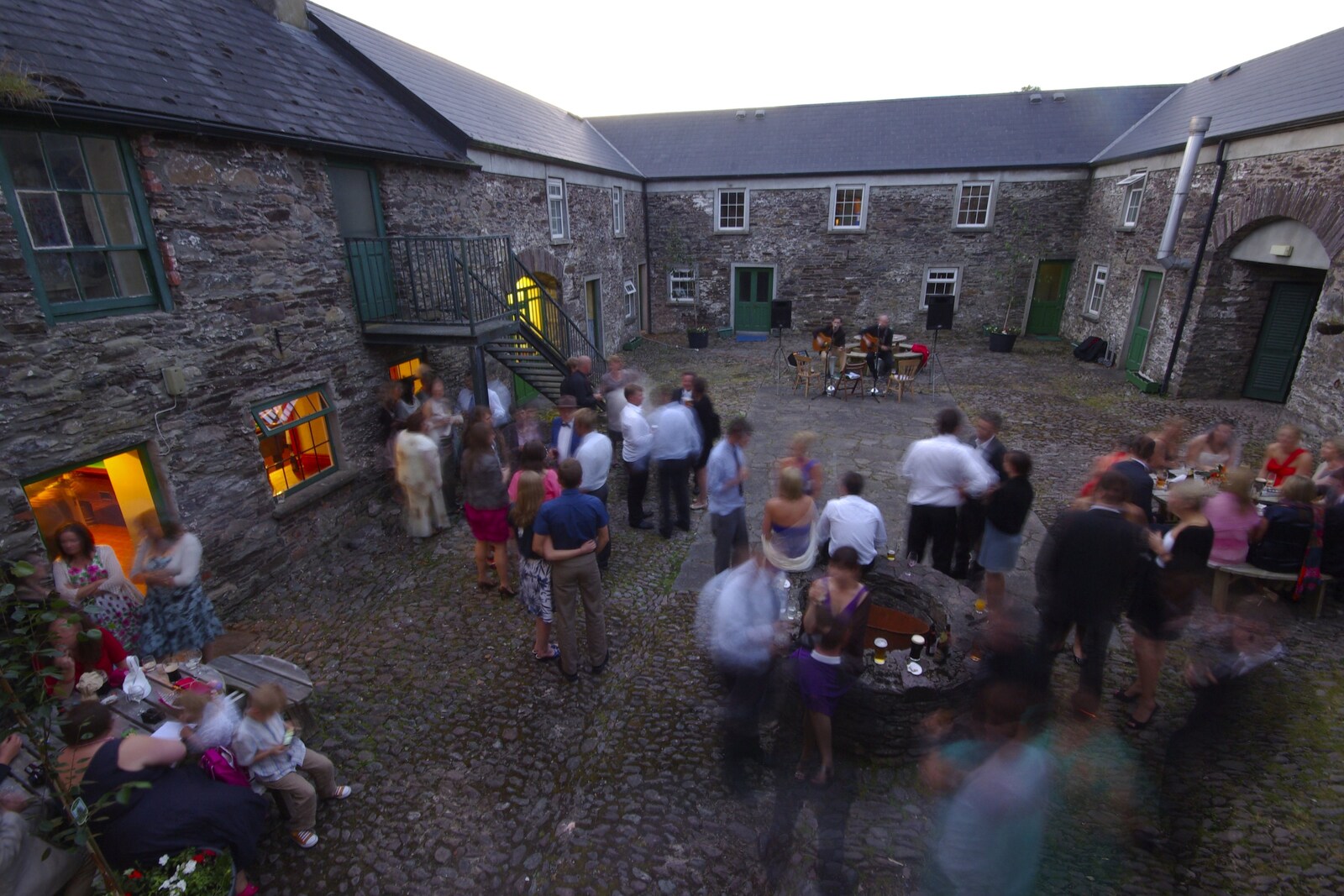 Guests are a blur in the courtyard from Julie and Cameron's Wedding, Ballintaggart House, Dingle - 24th July 2009
