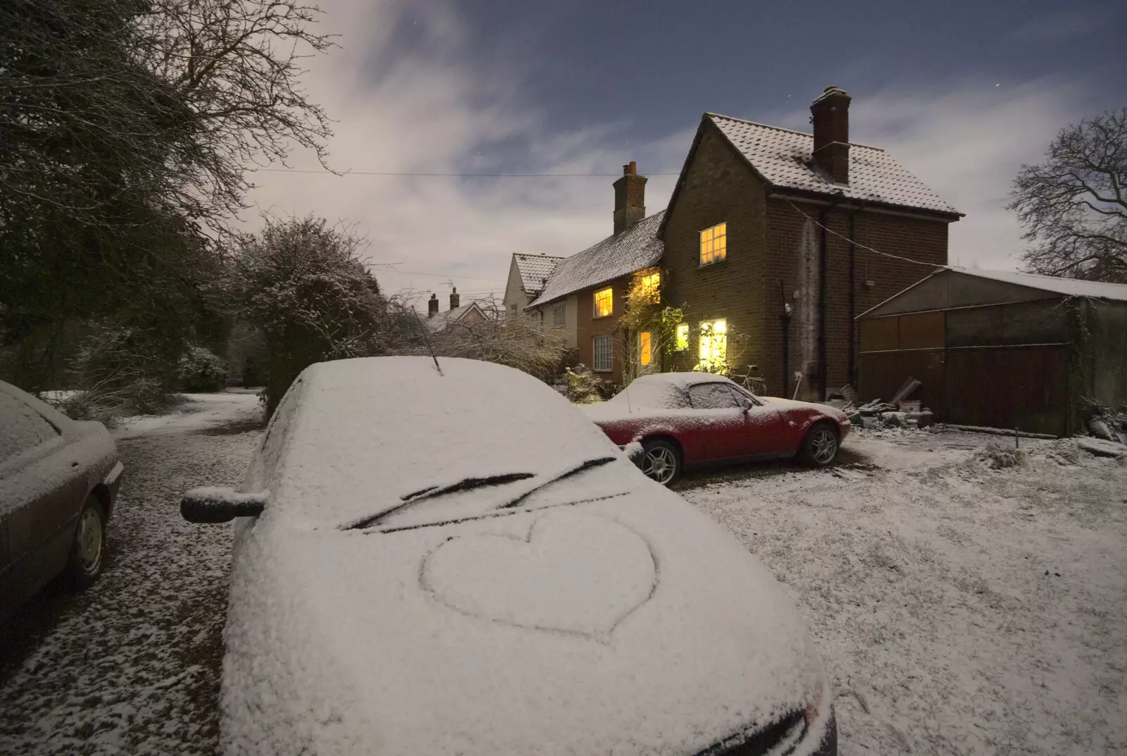 Nosher draws a heart on Isobel's car, from New Year's Eve at the Swan Inn, and Moonlight Photos, Brome, Suffolk - 31st December 2009