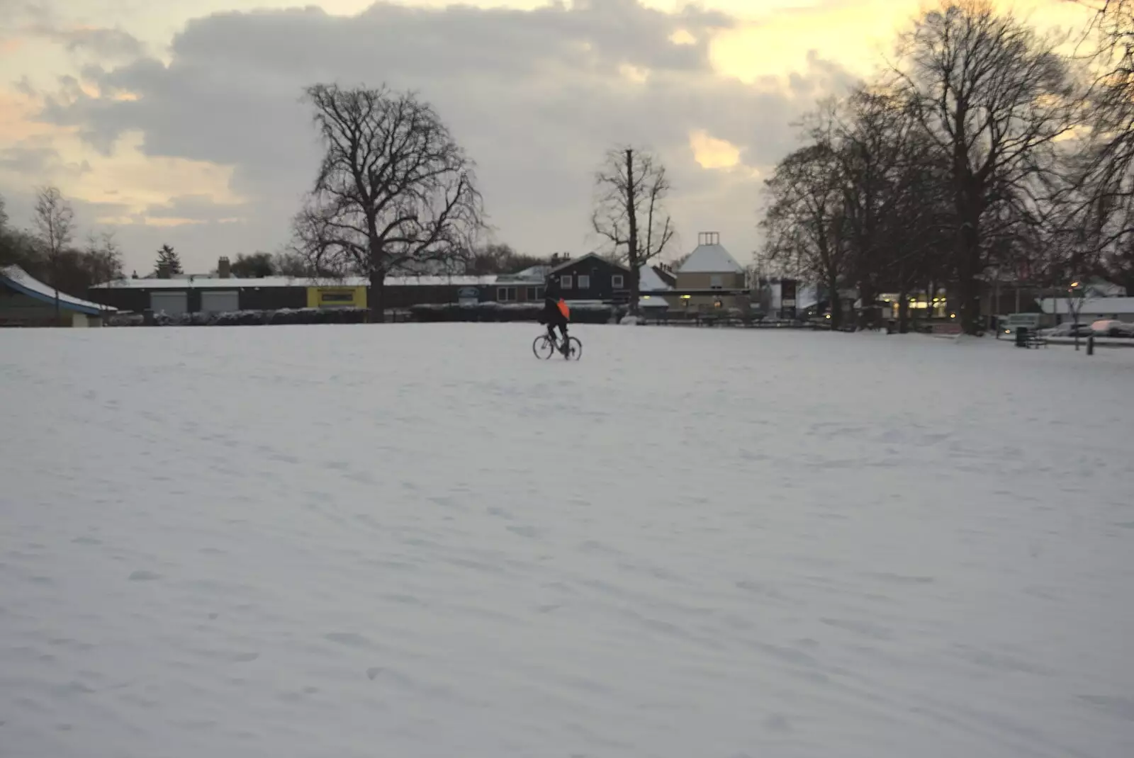 A paperboy cycles over the park in Diss, from A Snowy Miscellany, Diss, Norfolk - 9th January 2010