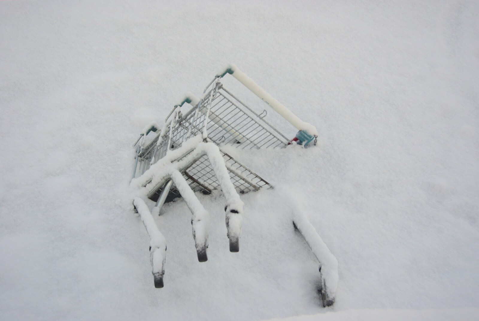 A Snowy Miscellany, Diss, Norfolk - 9th January 2010: Some more trolleys' legs stick out of the frozen Mere