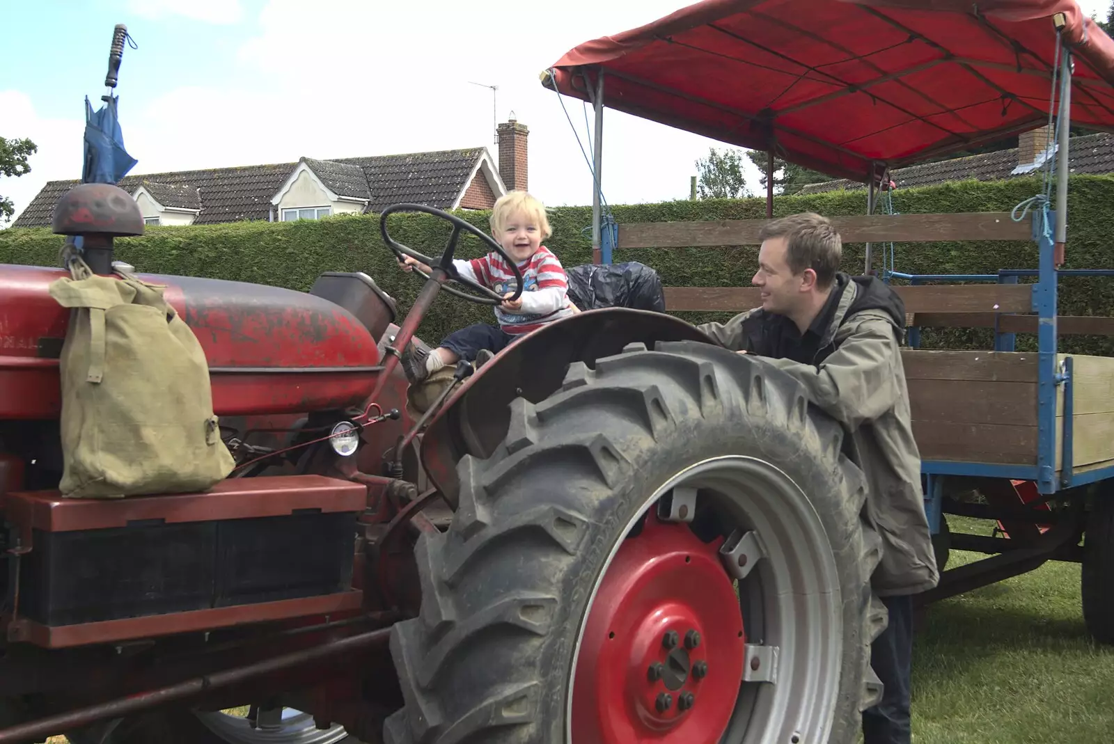 Nosher watches Fred on a tractor, from Fred at the Carnival, Brewer's Green Lane, Diss, Norfolk - 21st June 2010