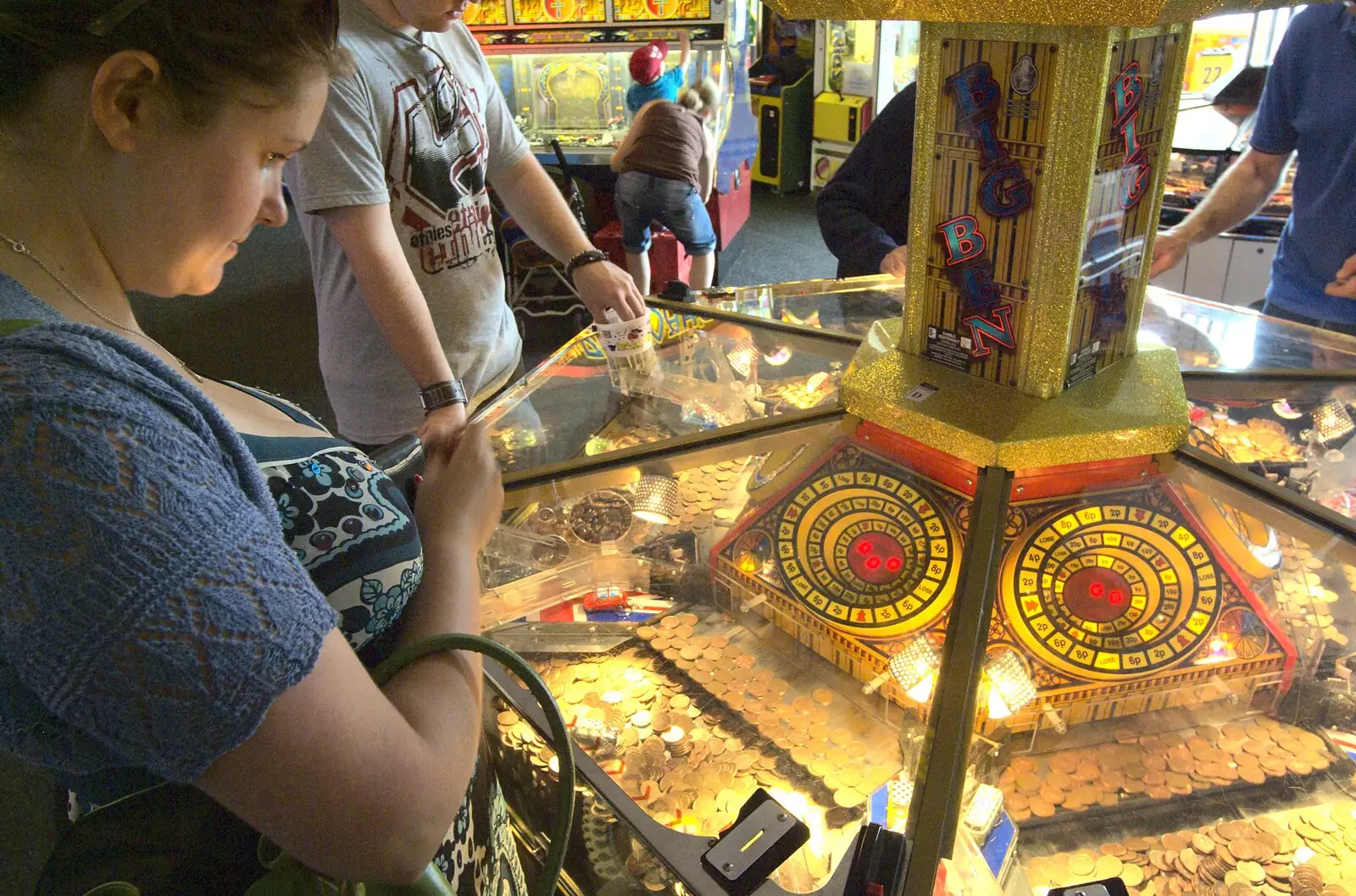 Isobel has a go at the coin push thing, from A "Minimoon" and an Adnams Brewery Trip, Southwold, Suffolk - 7th July 2010