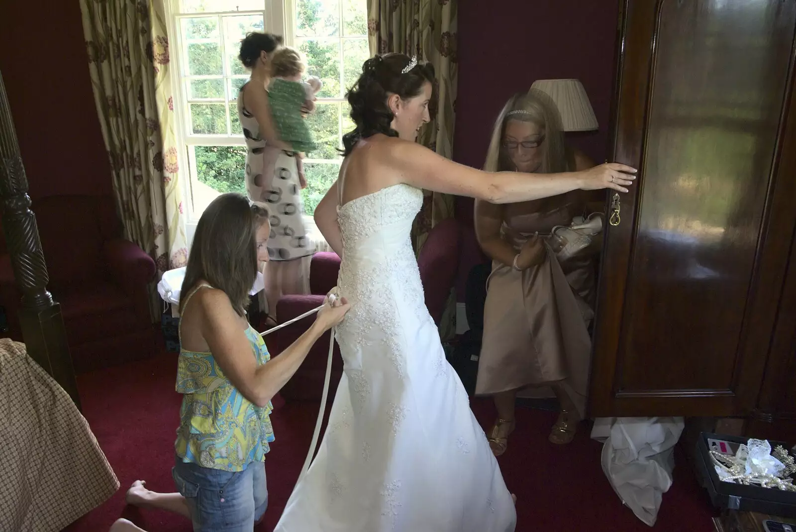 Suzanne hangs on to the wardrobe, from Clive and Suzanne's Wedding, Oakley and Brome, Suffolk - 10th July 2010