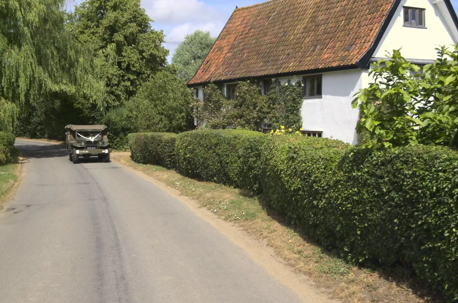 The Jeep heads past Dr. Vickery's house, from Clive and Suzanne's Wedding, Oakley and Brome, Suffolk - 10th July 2010