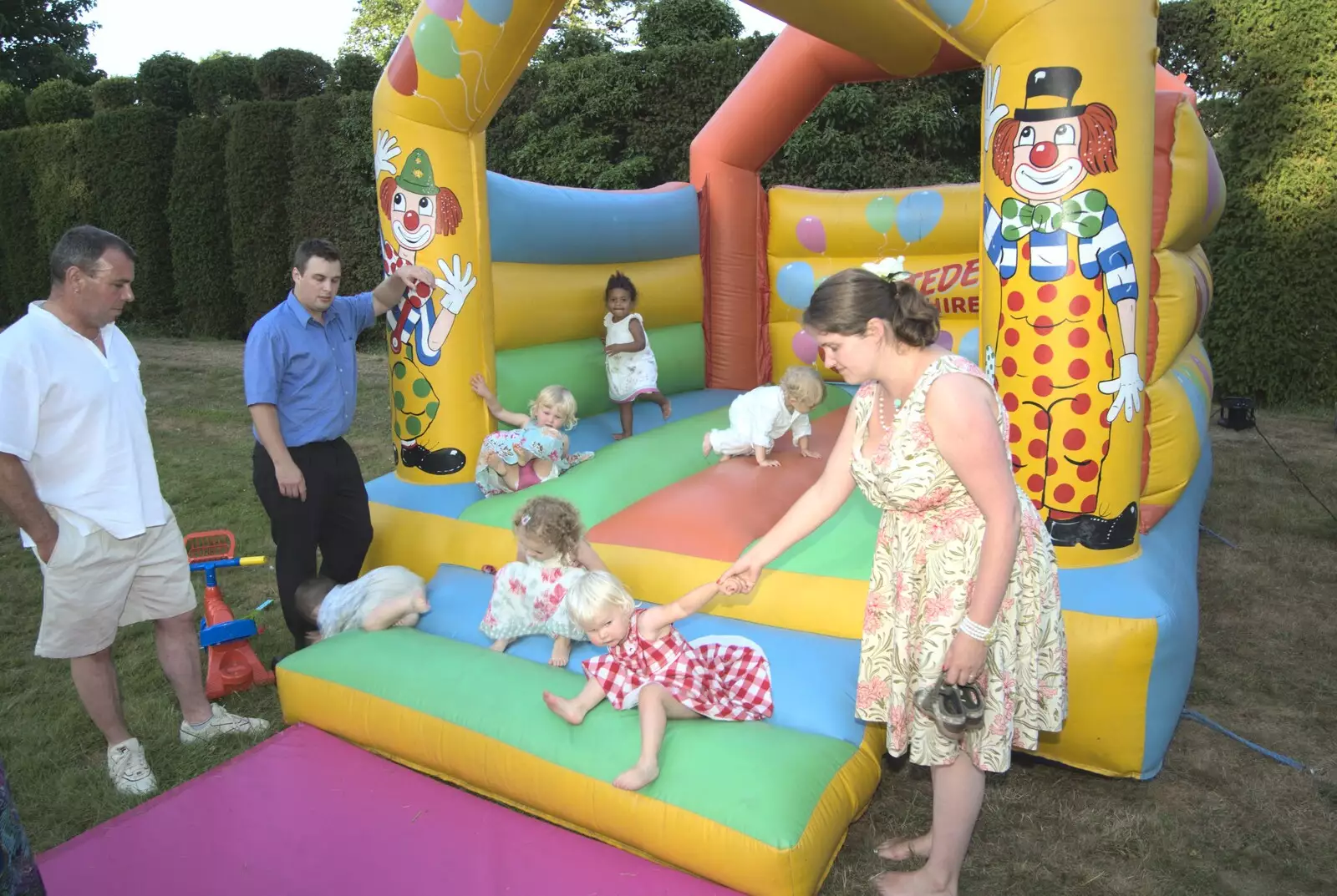 Isobel scoops a child off the inflatable, from Clive and Suzanne's Wedding, Oakley and Brome, Suffolk - 10th July 2010