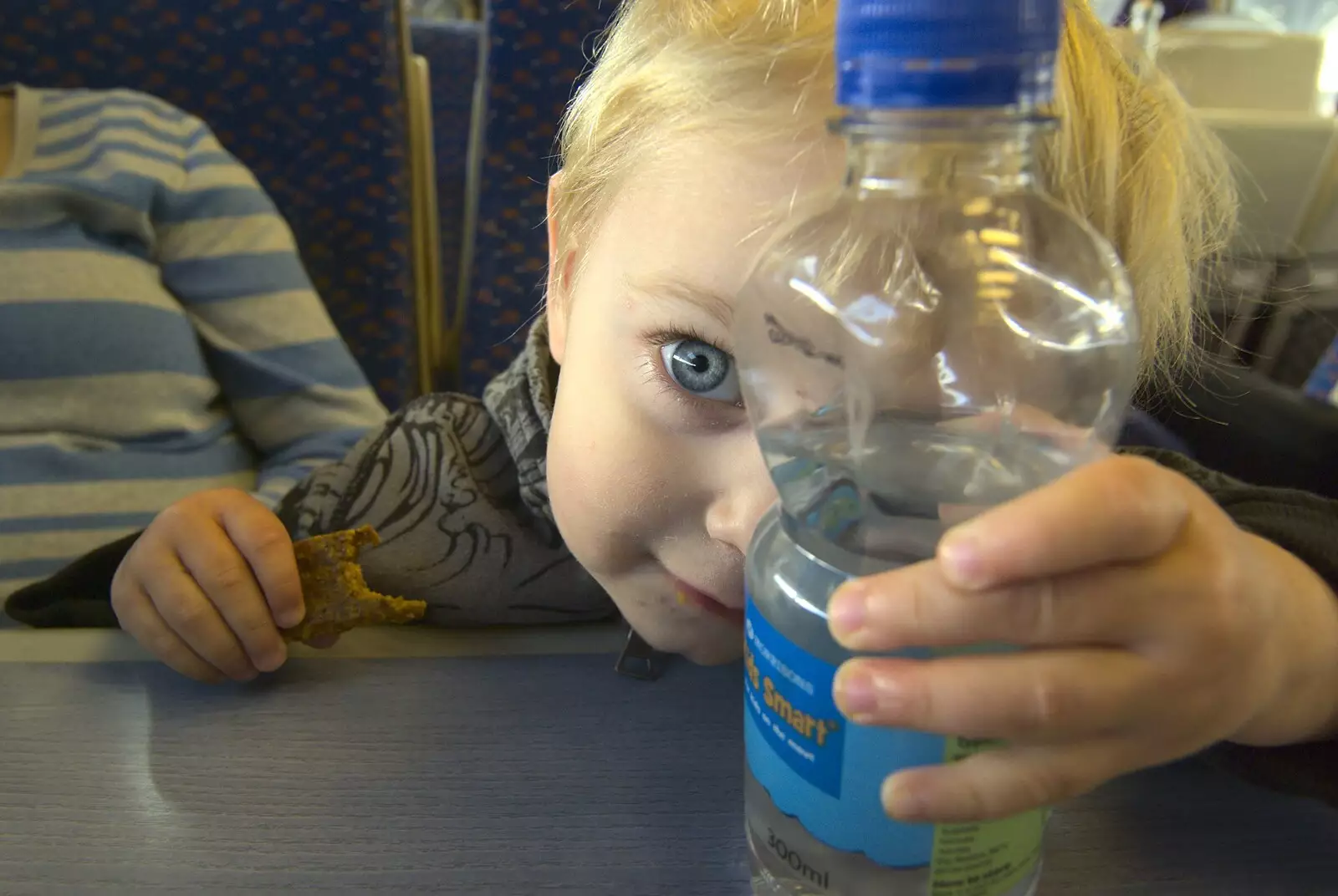 Fred looks through a bottle of water, from Norwich By Train, Norfolk - 16th October 2010