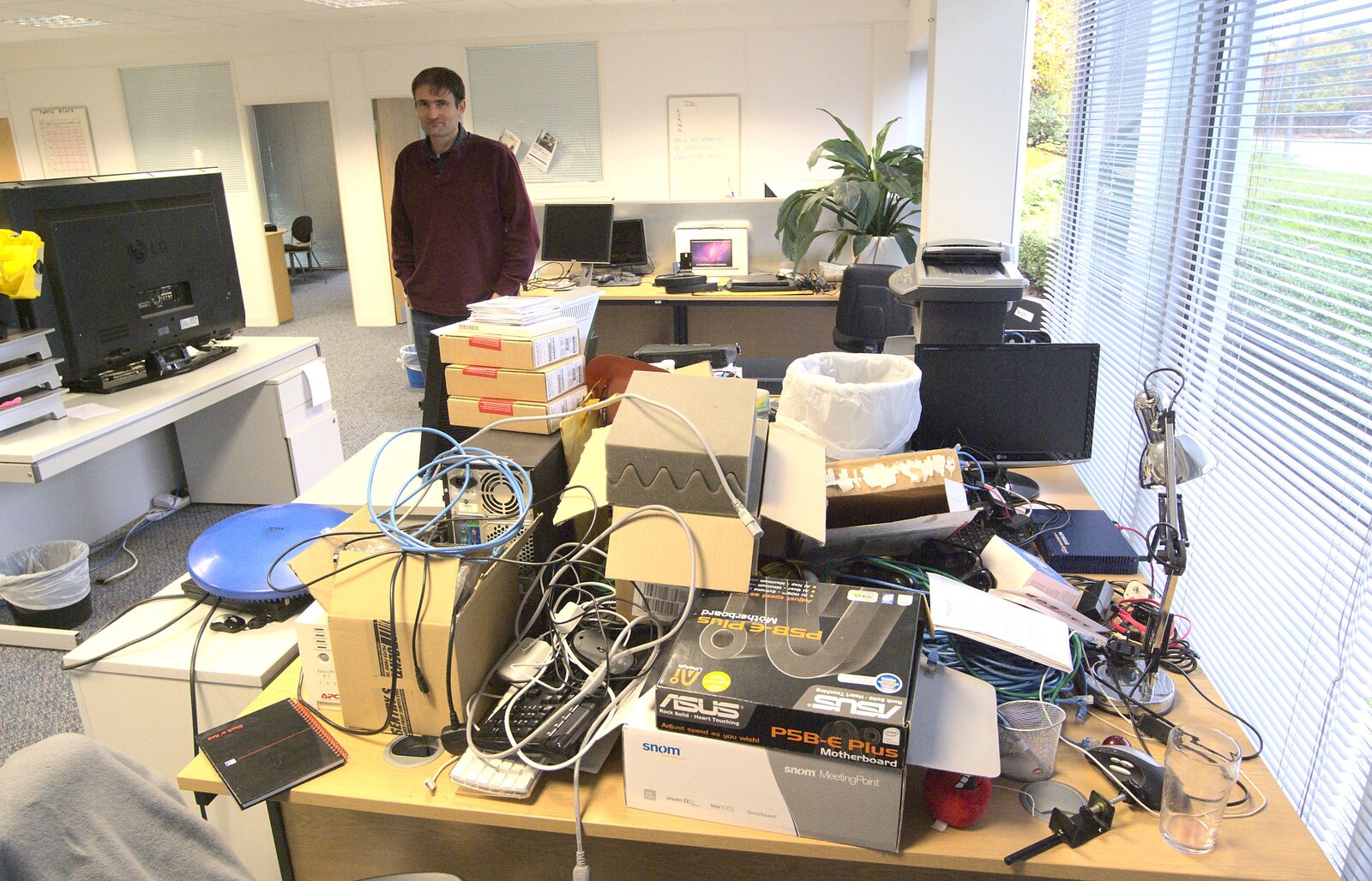 Bob looks over the pile of crap from Gemma Leaves, The Mellis Railway and Taptu Moves Desks, Cambridge - 24th October 2010
