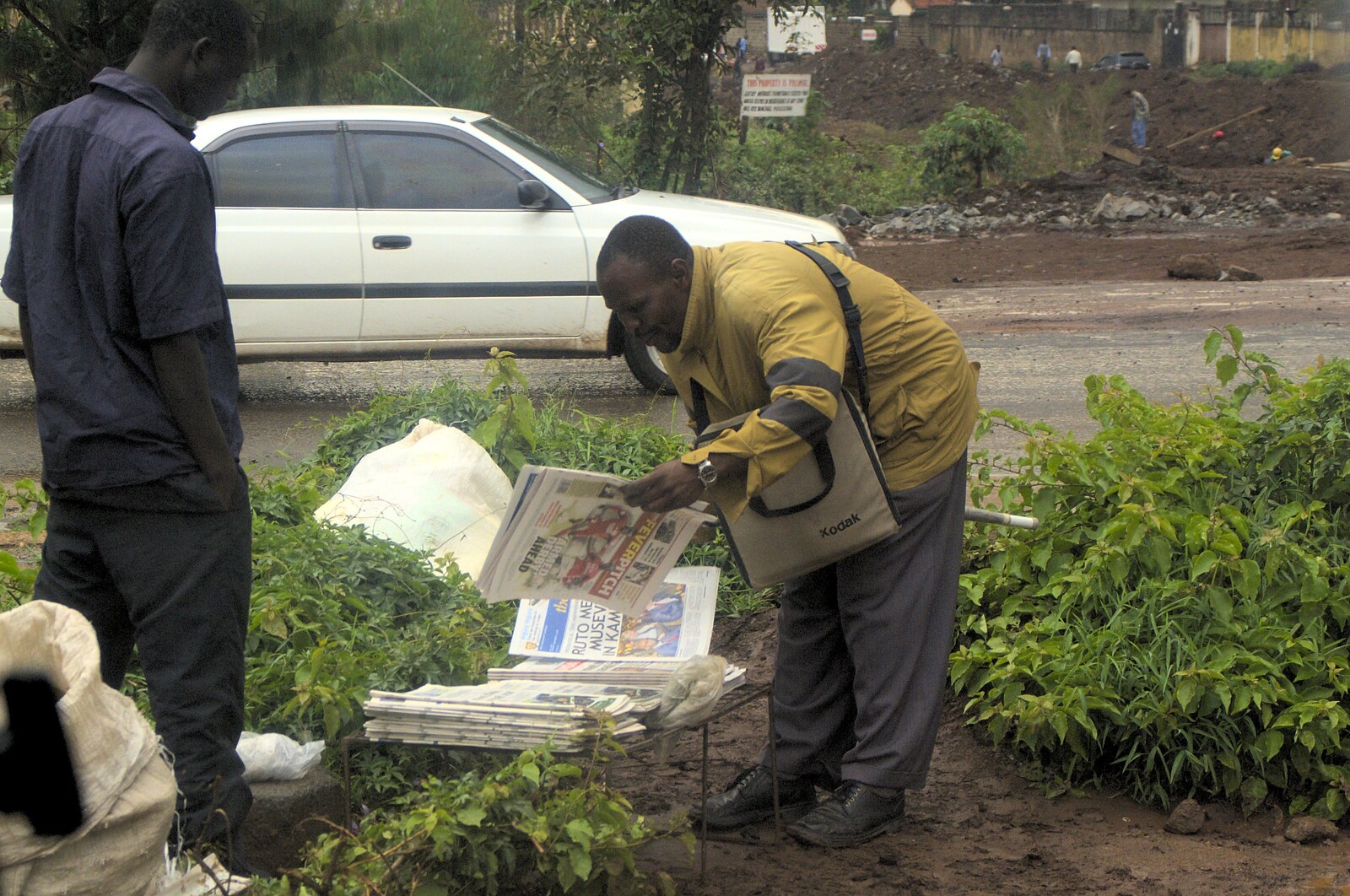 Some dude picks a newspaper up from Nairobi and the Road to Maasai Mara, Kenya, Africa - 1st November 2010