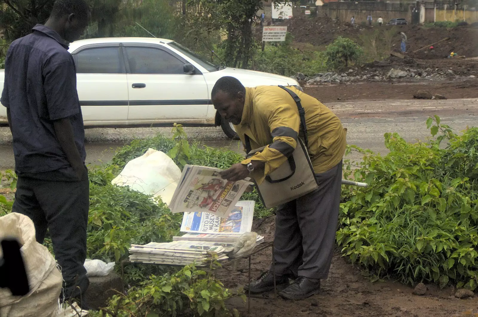 Some dude picks a newspaper up, from Nairobi and the Road to Maasai Mara, Kenya, Africa - 1st November 2010