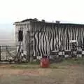 A zebra-striped hut looks out over the Rift Valley, Nairobi and the Road to Maasai Mara, Kenya, Africa - 1st November 2010