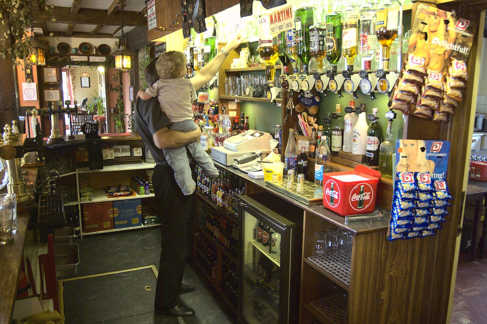 Alan lifts Fred up to explore behind the bar from Fred Visits The Swan, Brome, Suffolk - 5th February 2011
