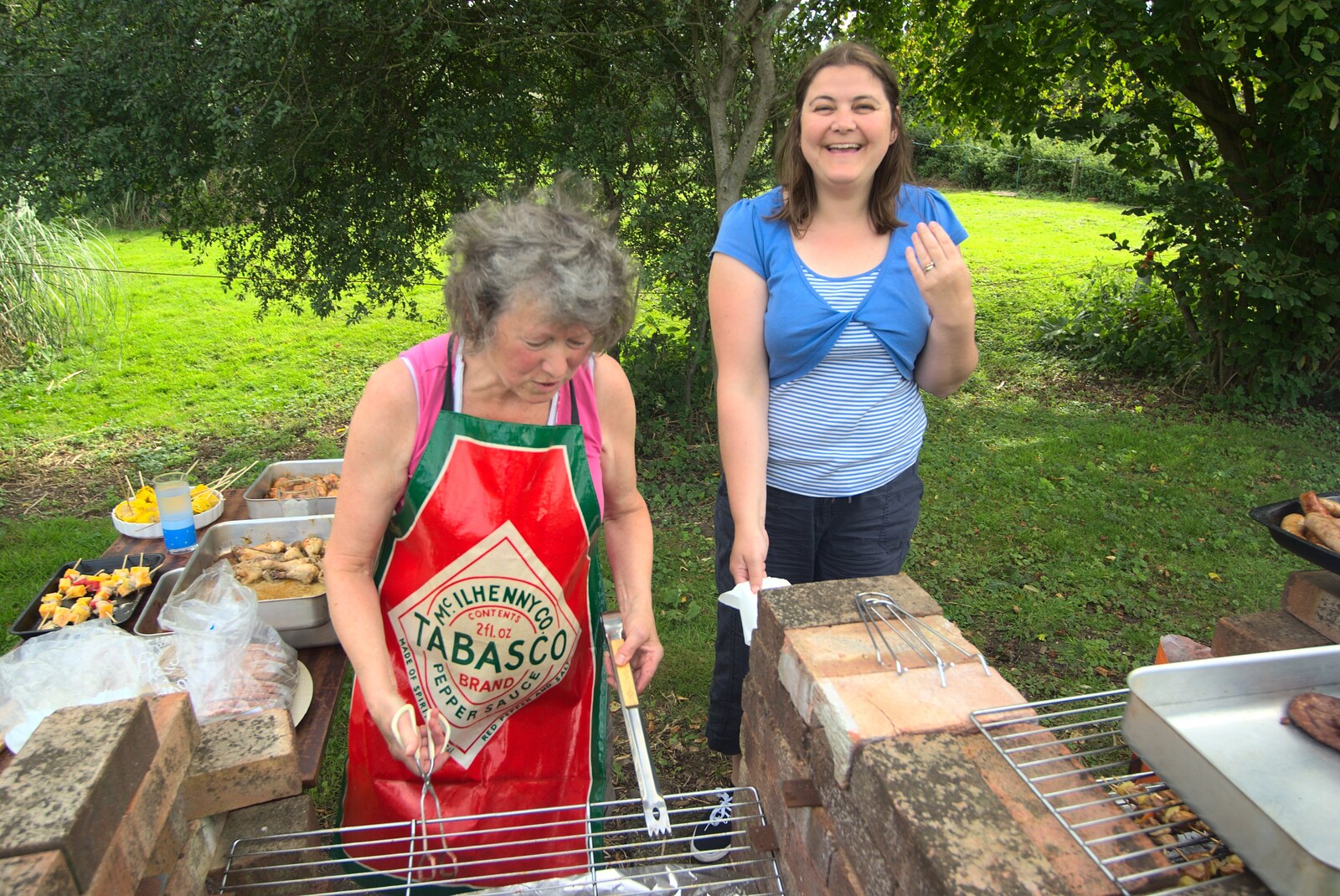 Sylvia and Claire are on barbeque duty from Barbeque at the Swan Inn, Brome, Suffolk - 5th August 2011