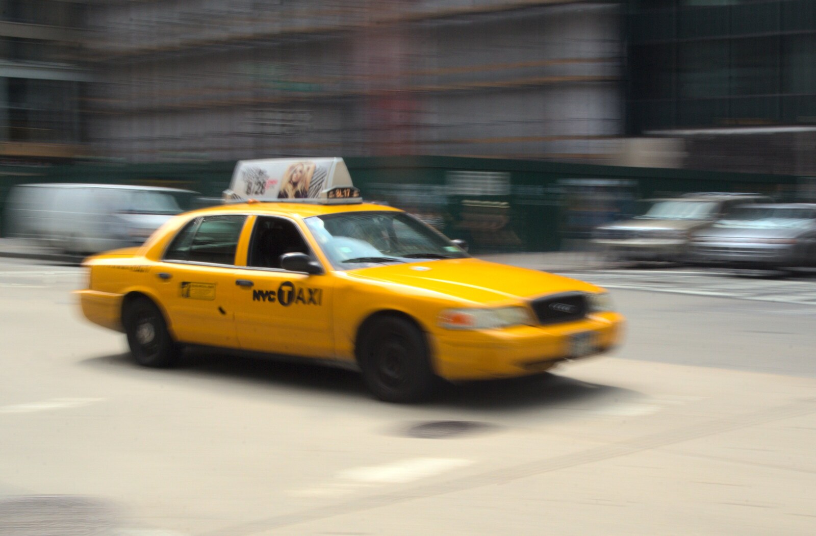 A New York cab steams across an intersection from A Manhattan Hotdog, New York, USA - 21st August 2011