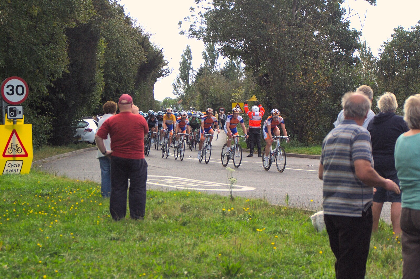 The main group of bikes appears from The Tour of Britain, Brome, Suffolk - 17th September 2011