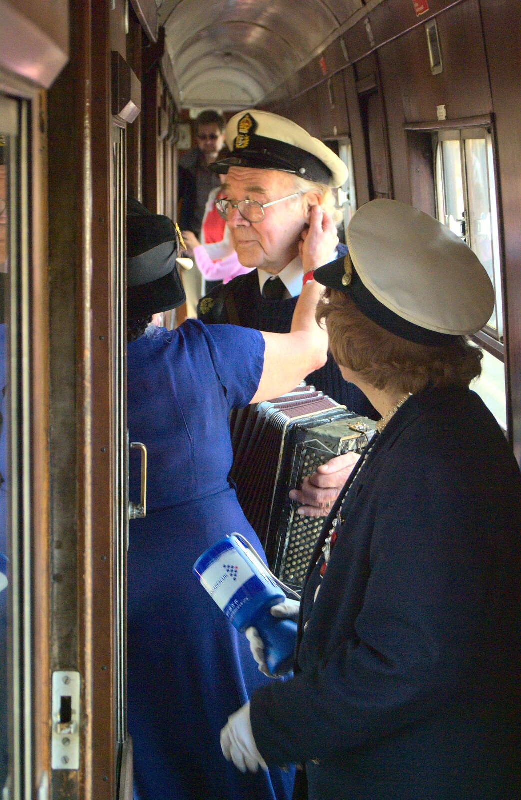 An accordion player does a tour of the carriages from The 1940s Steam Train Weekend, Holt, Norfolk - 18th September 2011